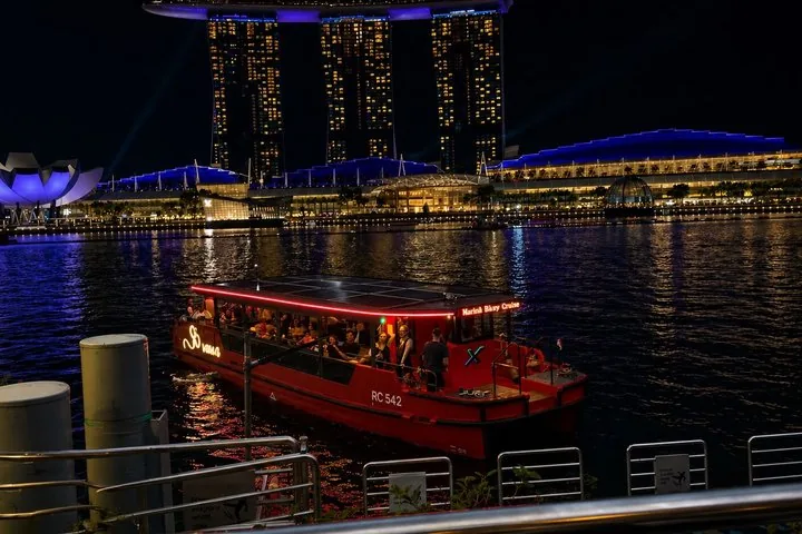 Red tour boat on Marina Bay with Marina Bay Sands in background